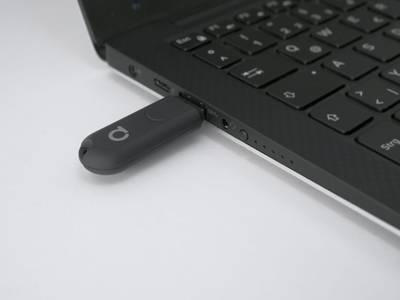 Memoria USB conectada a un ordenador portátil sobre fondo blanco, símbolo de conectividad y tecnología en las modernas soluciones de iluminación LED.