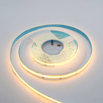 Tira de luz LED de brillo cálido trenzada sobre una superficie blanca: iluminación elegante y energéticamente eficiente para hogares y empresas.