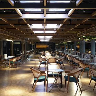 Un restaurante moderno con luz natural, iluminación de acento LED y un comedor muy bien iluminado.
