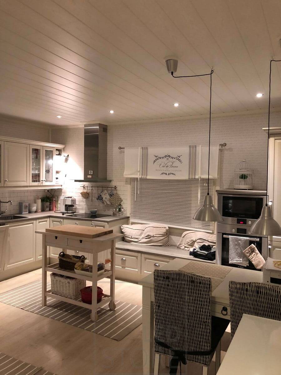 Iluminación de cocina con focos led en el borde de la estancia y lámparas colgantes sobre la mesa del comedor. Ledstore.fi