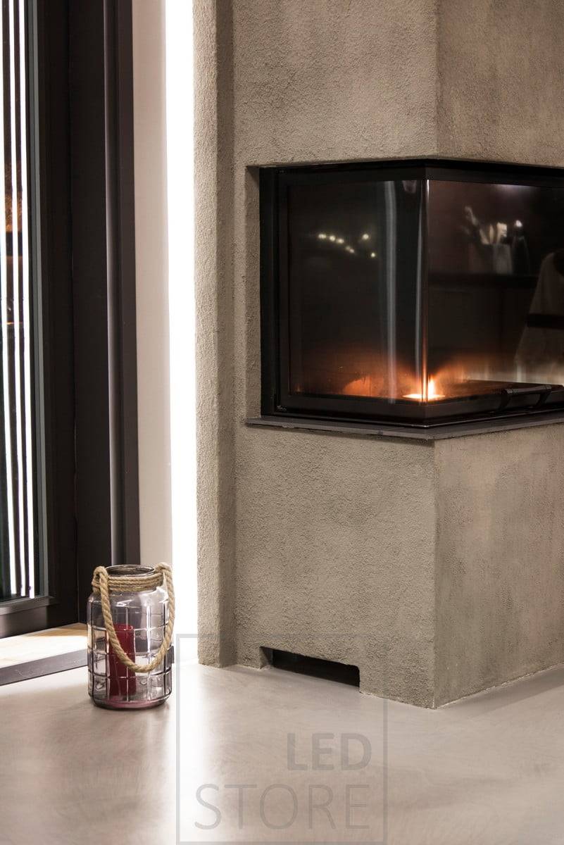 En el salón, detrás de la chimenea, una tira de LED proporciona una iluminación ambiental indirecta y suave a través de la pared. Ledstore.fi