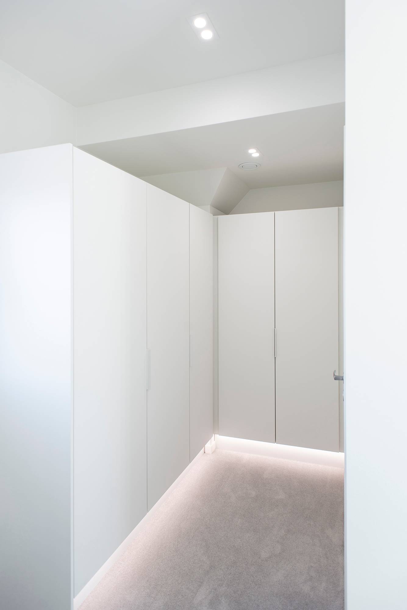 Tira de luz LED en perfil de aluminio en el zócalo que ilumina la luz indirecta, downlights TUPLA KANTTI en el techo. Ledstore.fi