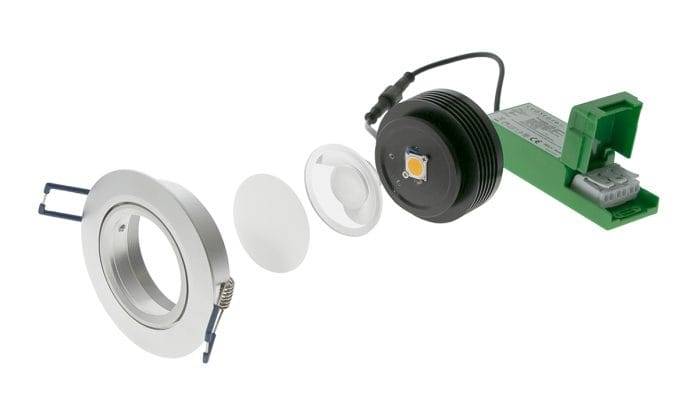 Despiece del downlight LED: cuerpo, lente, módulo LED y transformador verde.