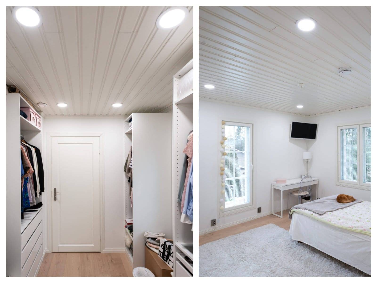 Armario con estantes iluminados con LED, suelo de madera; acogedora habitación con edredón blanco, TV montada en la pared, alfombra mullida. Las luces LED del techo iluminan ambos espacios.